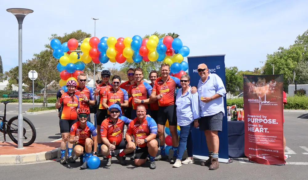Revived Pulse event group celebrating beneath colourful balloons